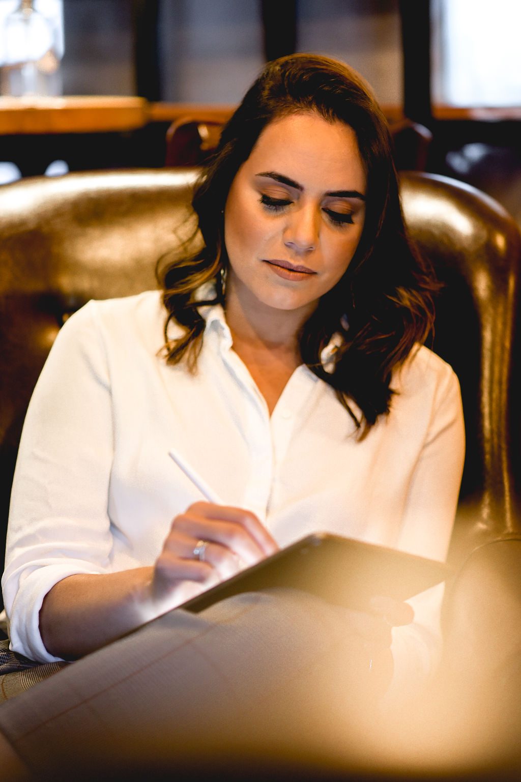 Talita Meira working on a laptop in a modern office